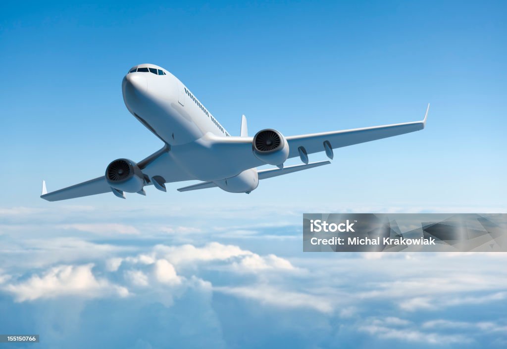 Mid Sized Passanger Airplane Flying Above Clouds.